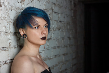 Fototapeta premium Fashion portrait of a beautiful woman with blue hair