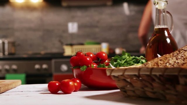 Sliding camera: woman prepares ingredients for cooking, washes broccoli