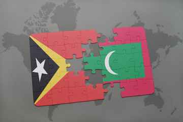 puzzle with the national flag of east timor and maldives on a world map background.