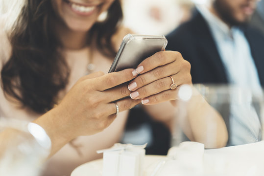 Close-up image of happy smiling woman using modern smartphone, young hipster girl with beautiful smile holding her cellphone and sending text message, social networking concept