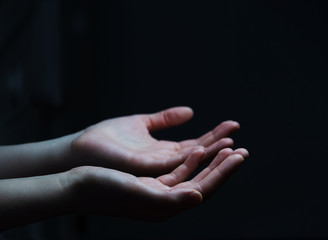 Businesswoman hand on black dark background