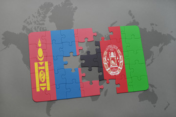 puzzle with the national flag of mongolia and afghanistan on a world map background.