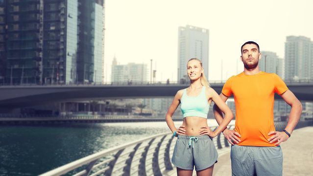 Couple Exercising Over Dubai City Street 