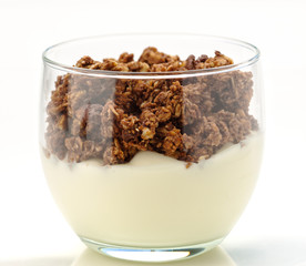 glass of yogurt with chocolate cereal isolated on white