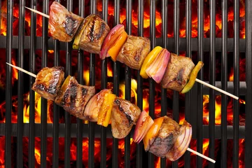 Gardinen Top view of red meat skewers being grilled in a barbecue. © michelaubryphoto