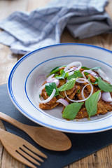 Spicy salad grilled pork with roasted grain, onions and basil