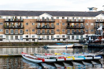 Row of boats decorated with different colours, moored in Millwall Outer Dock in London