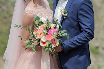 Bride holding a beautiful bridal bouquet. Wedding bouquet of peach roses by David Austin, ...