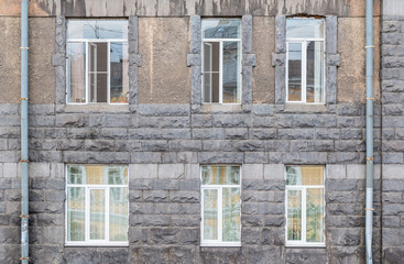 Fototapeta na wymiar Several windows in a row on facade of urban office building front view, St. Petersburg, Russia.