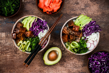 Hawaiian tuna poke bowl with seaweed, avocado, red cabbage, radishes and black sesame seeds