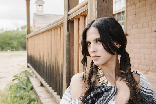 Portrait of a young woman with long brown hair in braids.