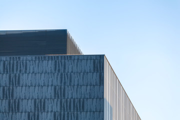 Fototapeta na wymiar Modern business building part against blue sky.