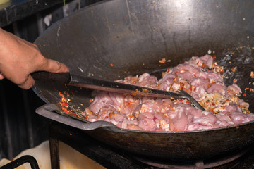 cooking meat in a frying pan
