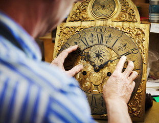 A clock maker displaying his work.