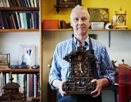 A clock maker displaying his work.
