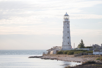 Fototapeta na wymiar Lighthouse stands on the beach