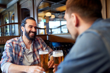 happy male friends drinking beer at bar or pub