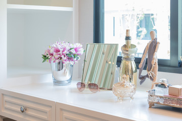 women's accesories on dressing white table