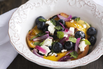 Summer salad with grilled peaches, blueberry and feta cheese