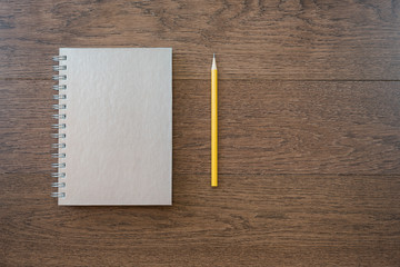 notebook with pencil on office wooden table