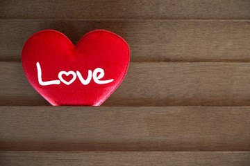 Red love heart on the wood wall.