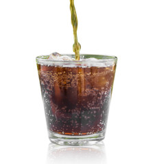 soft drink being poured into glass with ice cubes