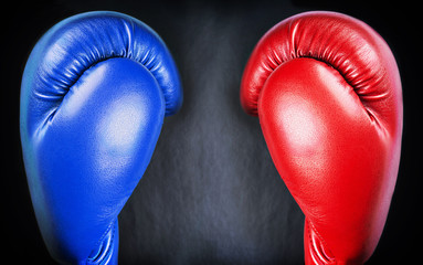 red and blue leather boxing gloves on a black background