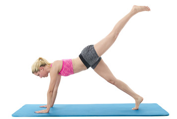 Fototapeta premium Young woman exercising on mat