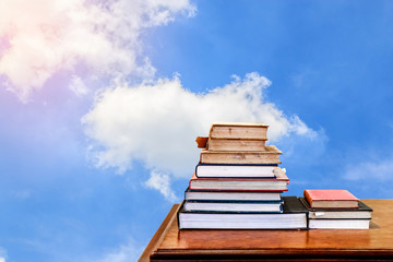 Books on the Table, with Background blue Sky and Sunlight.