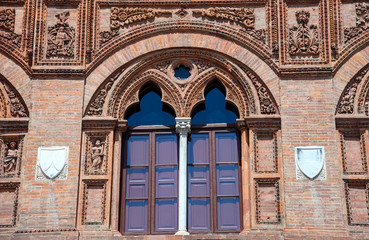 Fototapeta na wymiar artistic window in a red brick wall, Pisa, italy
