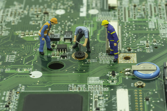 mini worker try to remove screw on mainboard