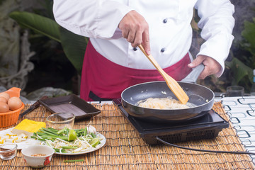 Chef stitr fried rice noodle for cooking Pad Thai