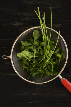 Parsley and baby spinach in vintage strainer