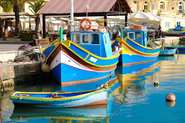 Fototapeta na wymiar Marsaxlokk famous fishing boats called Luzzu - Malta