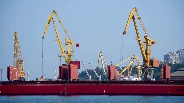Tower Cranes In The Port Loads The Sand In Hold