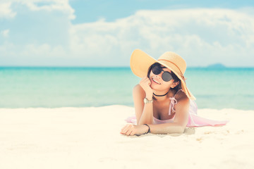 Asian girl at the beach. Girls wearing glasses lying on the beach. Woman at sea from Thailand. 