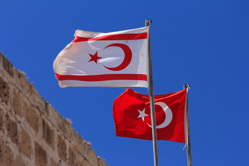 Flags Of The Turkish Republic Of Northern Cyprus and the Turkish Republic waving in the wind.