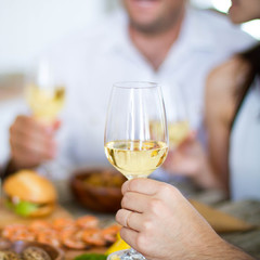 Wine, grape and cheese on wooden table