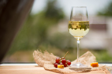 Wine, grape and cheese on wooden table