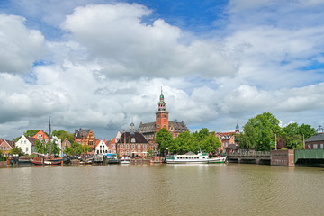 Leer, Germany. View from Leda river on City Hall in Dutch Renaissance style, Old Weigh House in...