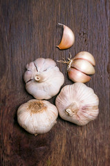 Garlic bulbs and cloves on wooden table