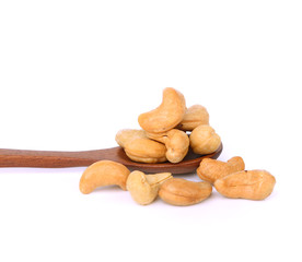 cashew nuts in woodend spoon isolated on white background