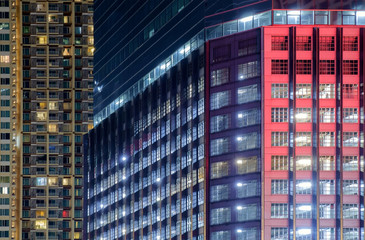 Fototapeta na wymiar Apartment building / View of balconies of apartment building at night.