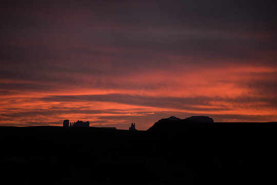 Red sunset in Goosenecks park showing Monument Valley of Arizona