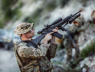 Army sniper during the military operation in the mountain. war,
