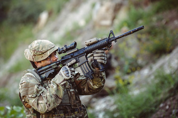 Army sniper during the military operation in the mountain. war,