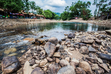 round rock in the river
Water flows from the mountain valleys Forest.Stone made a water slow...