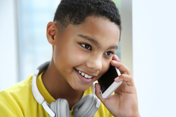 African American boy with headphones and cellphone