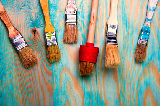 Painting brushes on blue wooden table