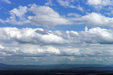 Naklejka na ściany i meble Clouds view on blue sky background, summer